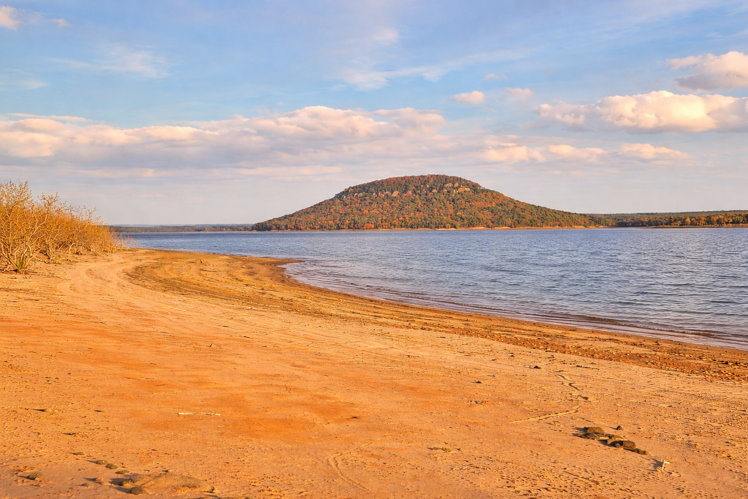 Sandy beach with a view toward Sugarloaf Mountain on Greers Ferry Lake